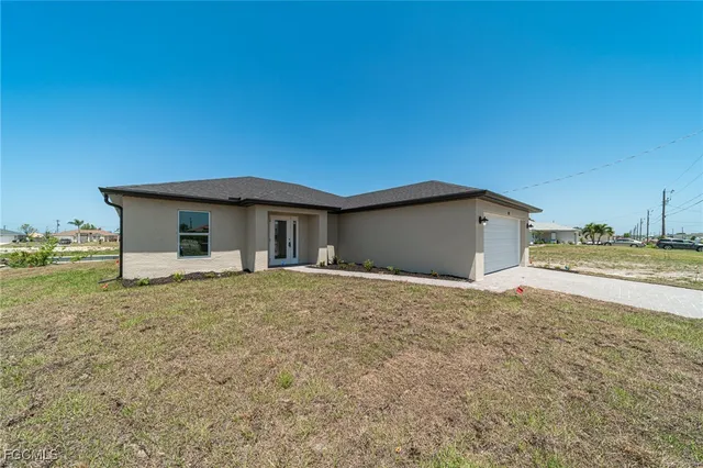 a view of a wooden house with a yard
