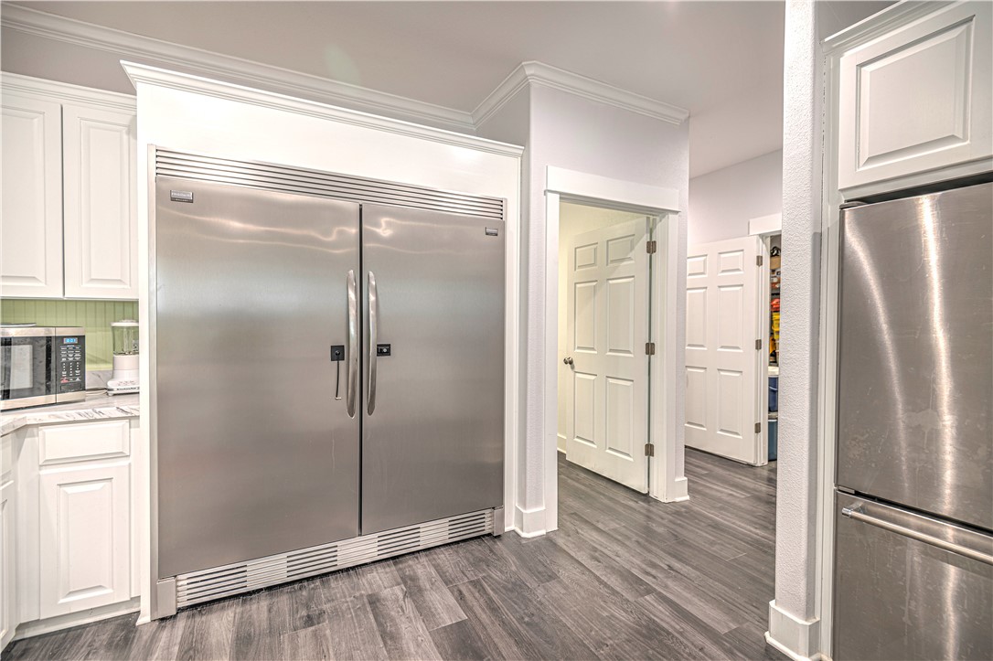 4948 Woodlawn Road Lorena, TX 76655 - Photo 18 of 48 a view of a refrigerator in kitchen and wooden floor
