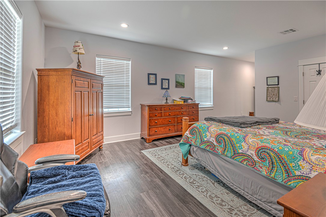 4948 Woodlawn Road Lorena, TX 76655 - Photo 26 of 48 a bedroom with a bed and wooden floor