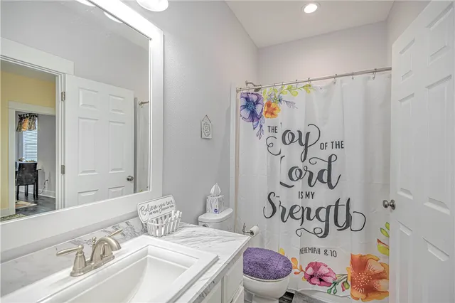 a view of a bathroom from a hallway