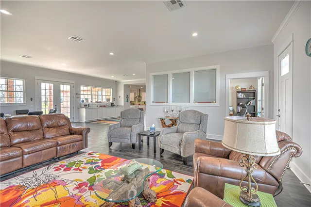 a living room with furniture and a dining table