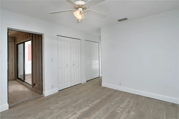 a bathroom with a granite countertop sink a mirror a shower and a bathtub
