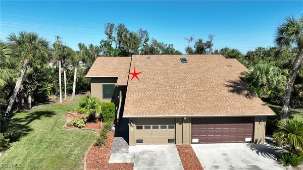 a aerial view of a house with a yard and a garage