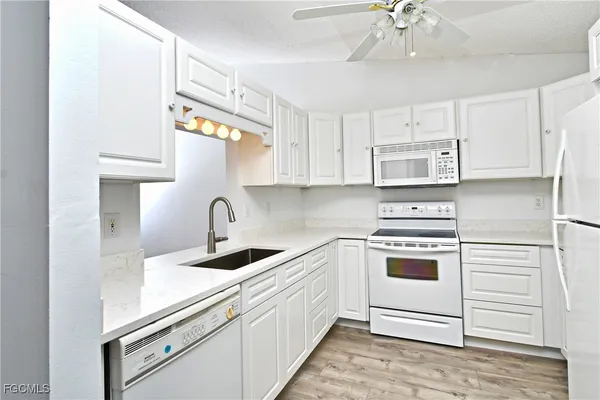 a white refrigerator freezer sitting in a kitchen