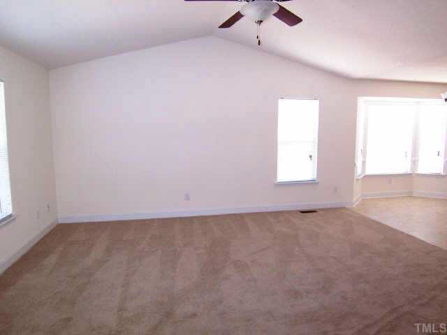 713 Lynn Road Durham, NC 27703 - Photo 2 of 5 Living Room with vaulted ceiling and mini blinds throughout entire house.