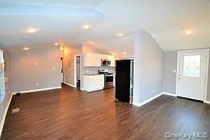 a view of kitchen with refrigerator and microwave