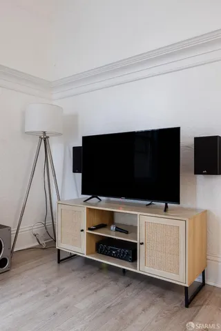 a living room with a flat screen tv and white walls
