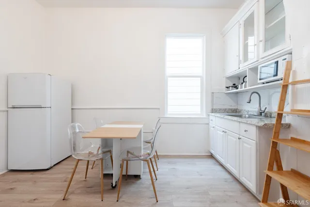 a kitchen with stainless steel appliances granite countertop a sink and a refrigerator
