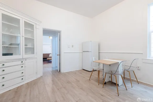 a view of a room with furniture and wooden floor