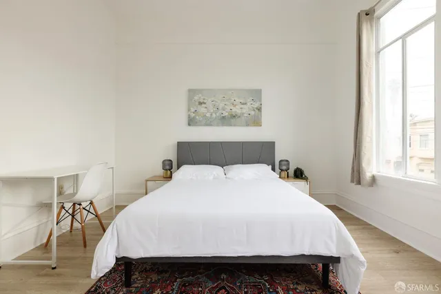 a bedroom with a bed and a window