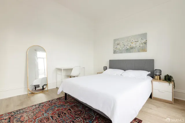 a bedroom with a large bed and a window