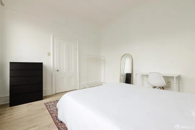 a bedroom with a bed and a dresser