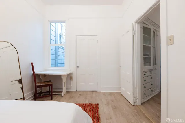 a view of room with window and wooden floor
