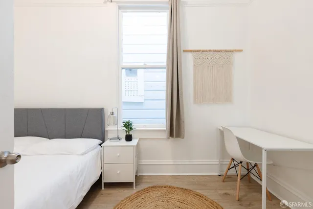 a bedroom with a bed and a table in it