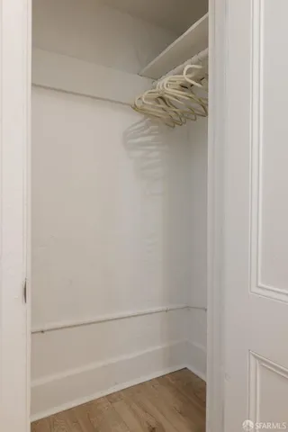 a view of walk in closet with empty racks