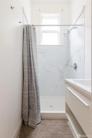 a bathroom with a shower and a tub