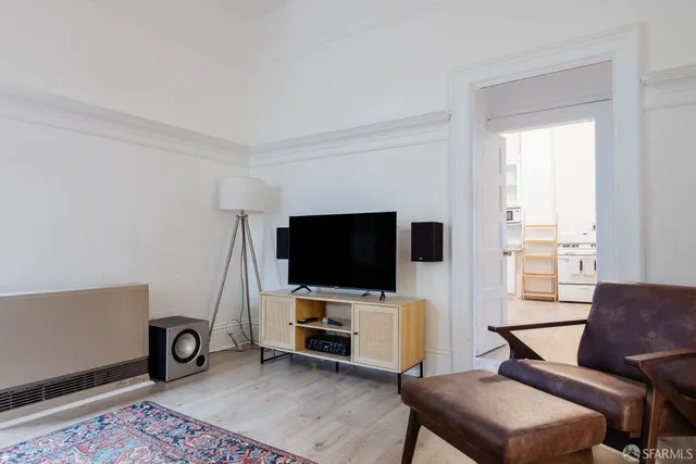 a view of a livingroom with furniture and a flat screen tv