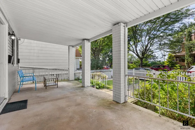 a bathroom with a toilet a sink a mirror and a window