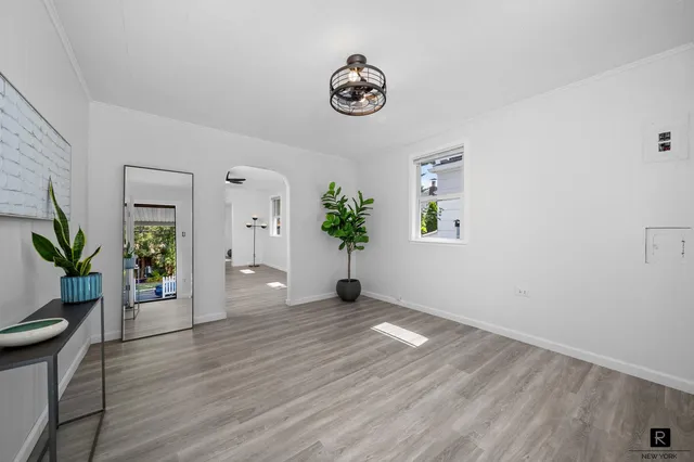 a view of a patio with chairs and table under an umbrella
