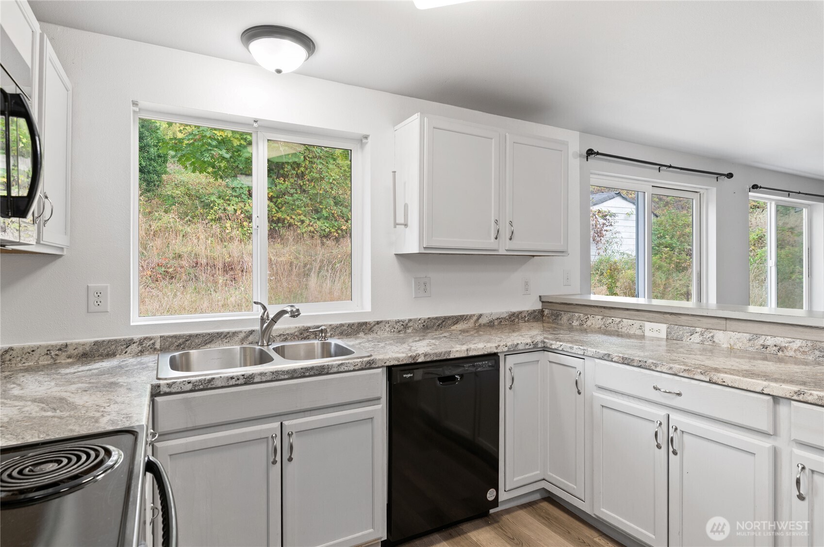 5151 East Pickering Road Shelton, WA 98584 - Photo 11 of 27 a kitchen with a sink cabinets appliances and a window
