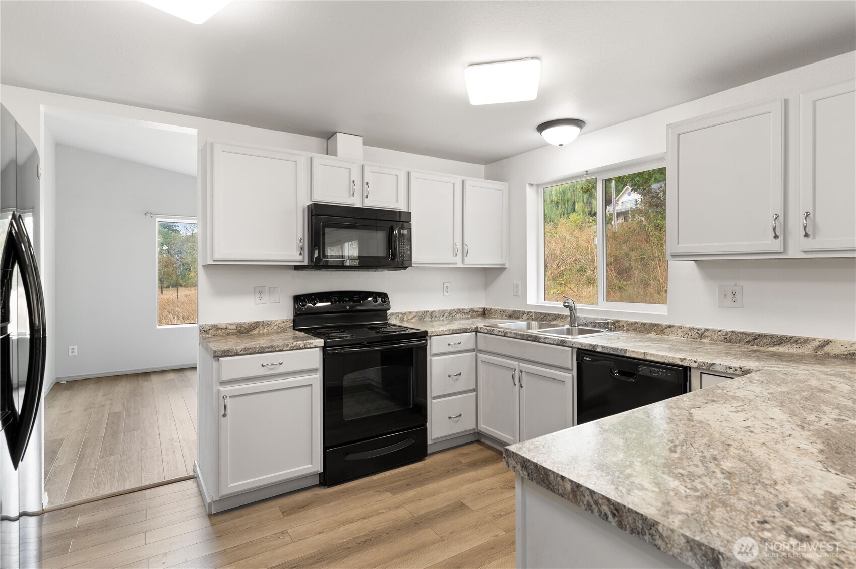 5151 East Pickering Road Shelton, WA 98584 - Photo 12 of 27 a kitchen with granite countertop a stove top oven sink and cabinets