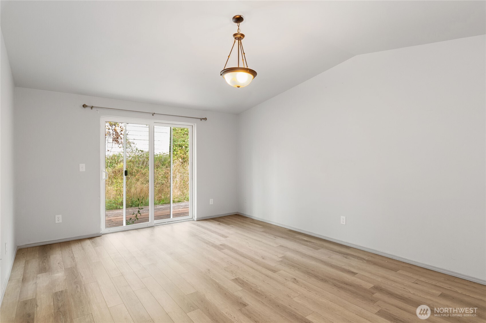 5151 East Pickering Road Shelton, WA 98584 - Photo 16 of 27 an empty room with wooden floor and windows