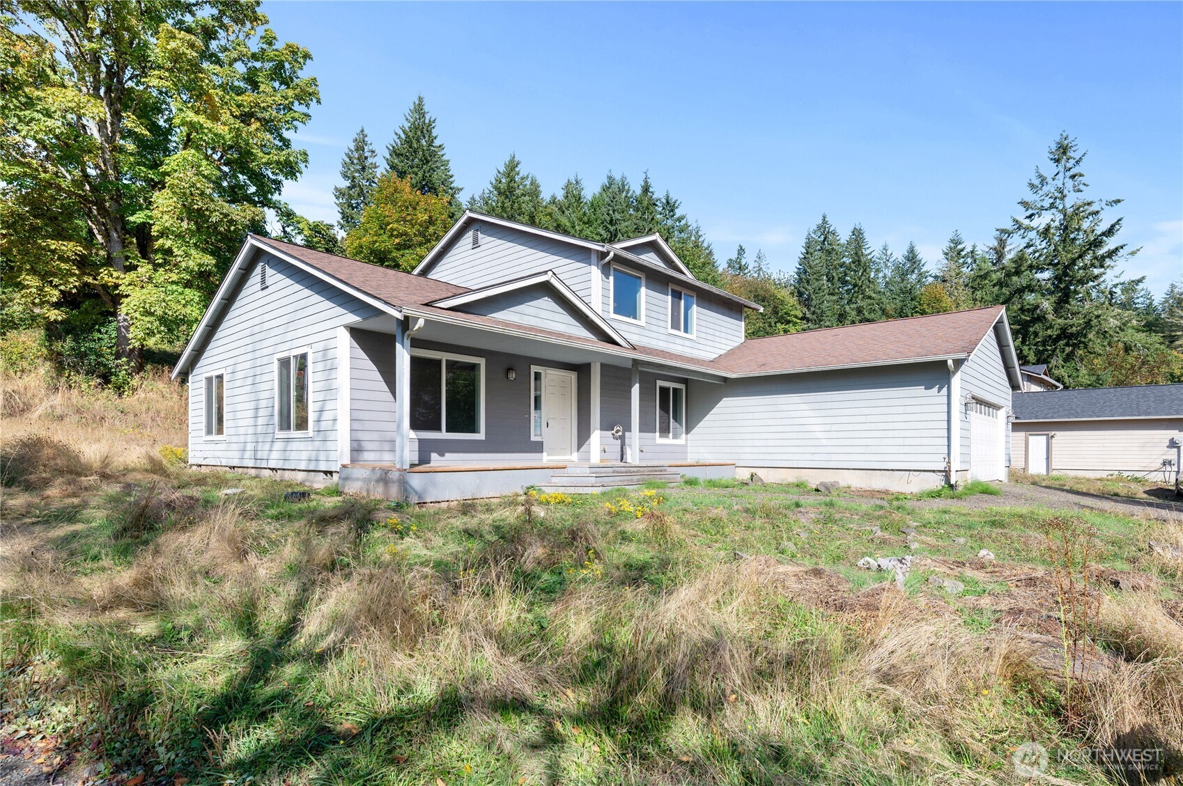 5151 East Pickering Road Shelton, WA 98584 - Photo 2 of 27 a view of a yard in front of a house with large trees