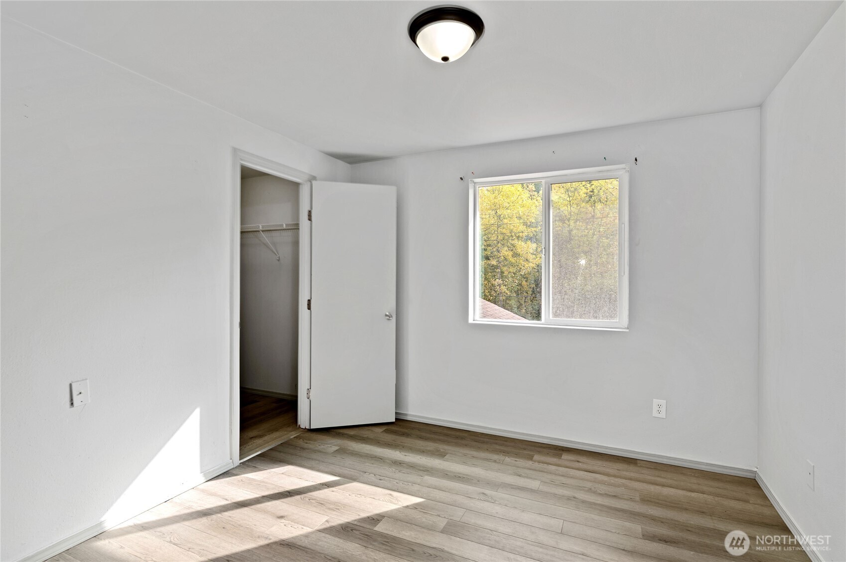 5151 East Pickering Road Shelton, WA 98584 - Photo 22 of 27 an empty room with wooden floor and windows