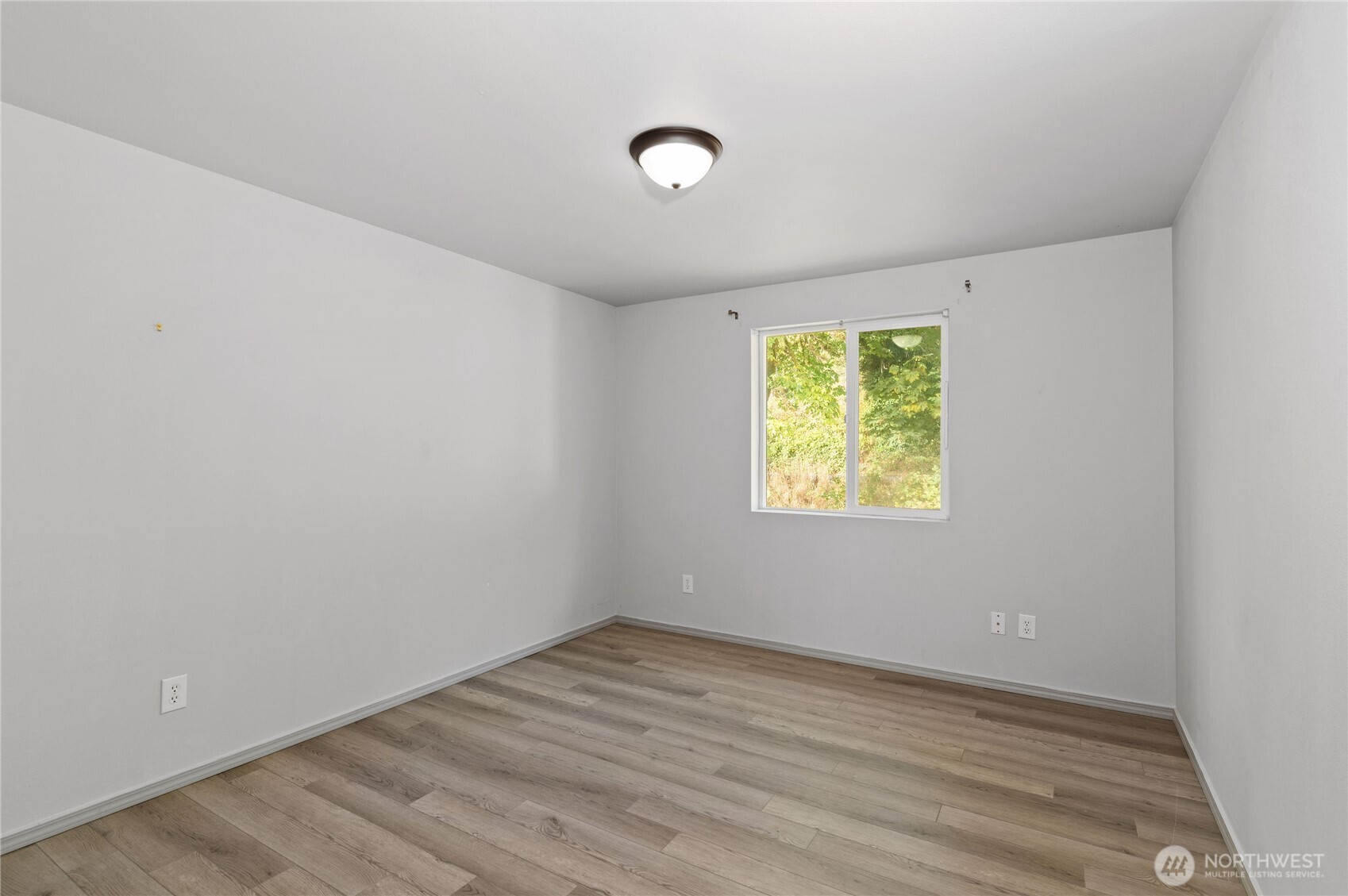 5151 East Pickering Road Shelton, WA 98584 - Photo 23 of 27 a view of an empty room with wooden floor and a window