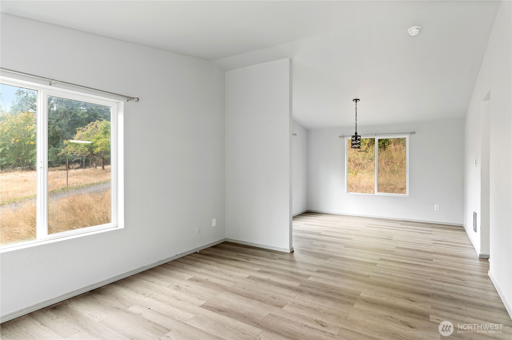 5151 East Pickering Road Shelton, WA 98584 - Photo 6 of 27 a view of an empty room with wooden floor and a window