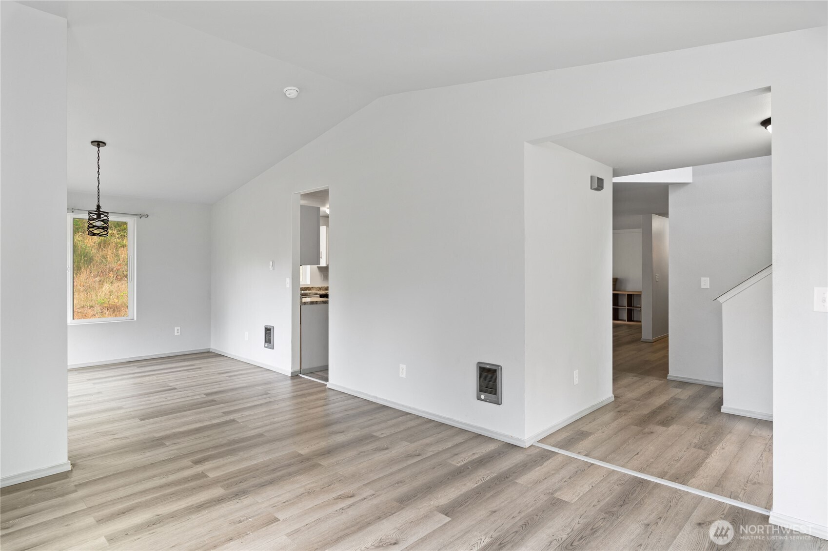 5151 East Pickering Road Shelton, WA 98584 - Photo 7 of 27 an empty room with wooden floor and windows