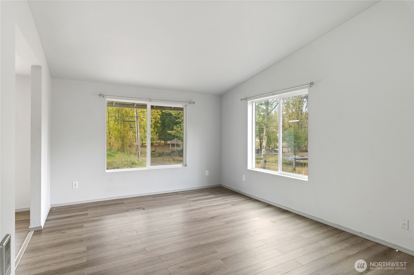 5151 East Pickering Road Shelton, WA 98584 - Photo 8 of 27 an empty room with wooden floor and windows