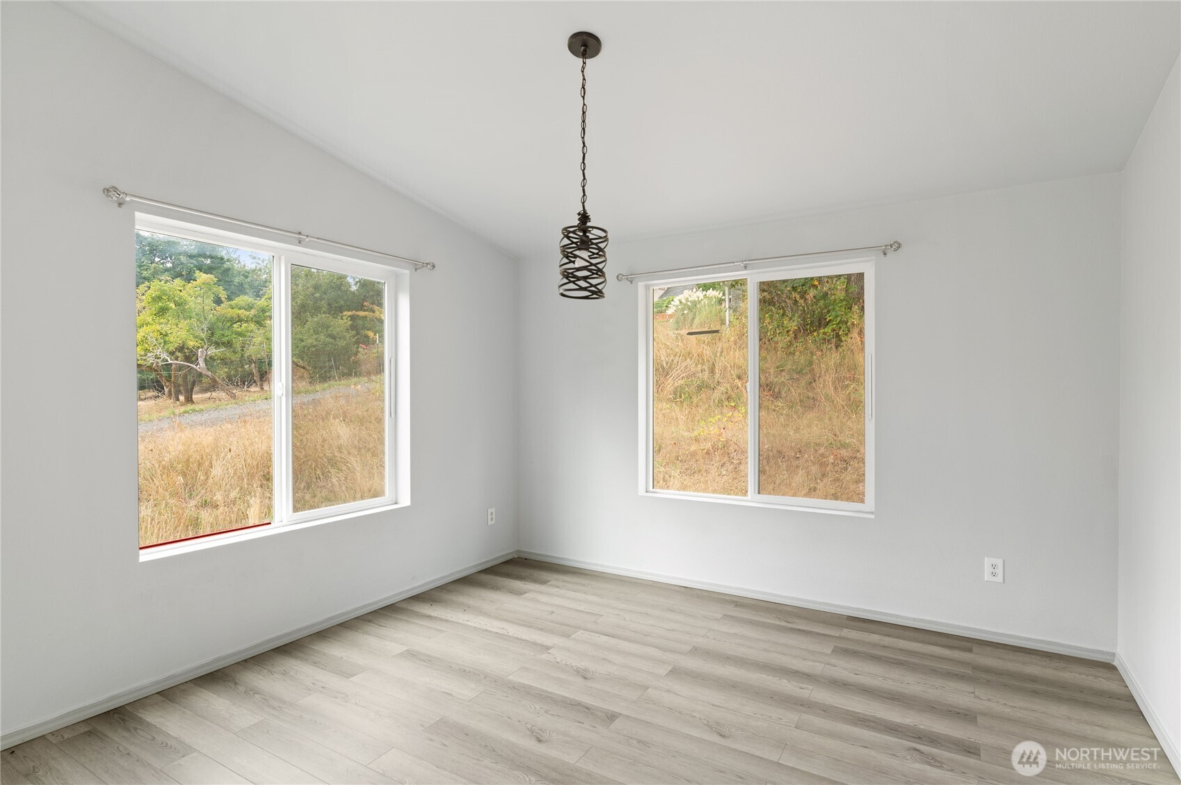 5151 East Pickering Road Shelton, WA 98584 - Photo 9 of 27 a view of an empty room with a window and wooden floor