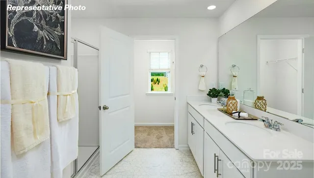 a bathroom with a granite countertop tub a sink and a large mirror