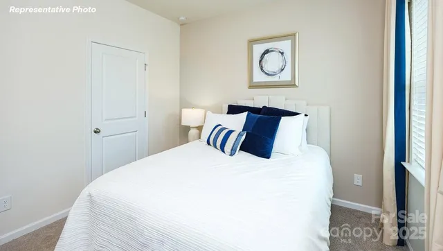 a bedroom with a bed and a wall painting