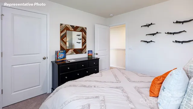 a bedroom with a bed and a dresser in it