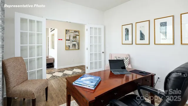 a view of a workspace with furniture and a potted plant