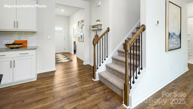 a view of entryway and hall with wooden floor