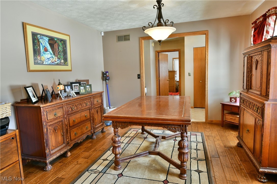 5915 Downs Road Northwest Warren, OH 44481 - Photo 4 of 50 Dining area with hardwood / wood-style flooring and a textured ceiling