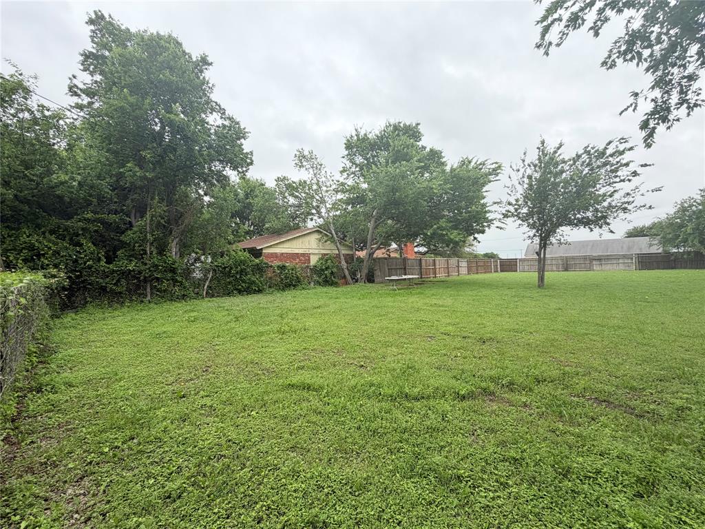 5633 Oak Grove Road Fort Worth, TX 76134 - Photo 5 of 7 a view of green field with tree in the background