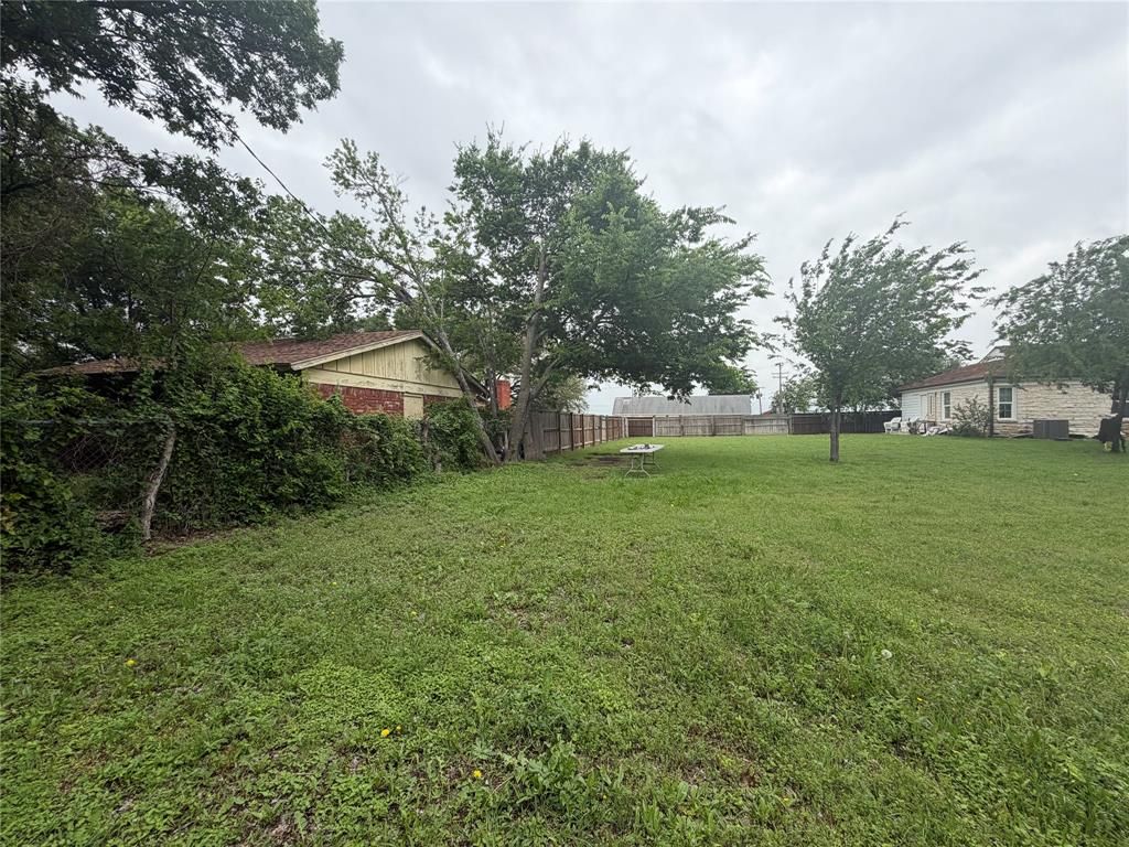 5633 Oak Grove Road Fort Worth, TX 76134 - Photo 6 of 7 a view of a house with a big yard
