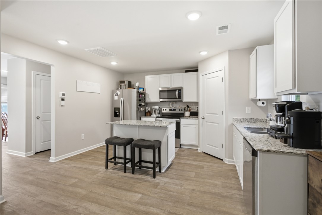1055 South Depot Street Seneca, SC 29678 - Photo 11 of 43 This modern kitchen features a spacious island and bright recessed lighting.