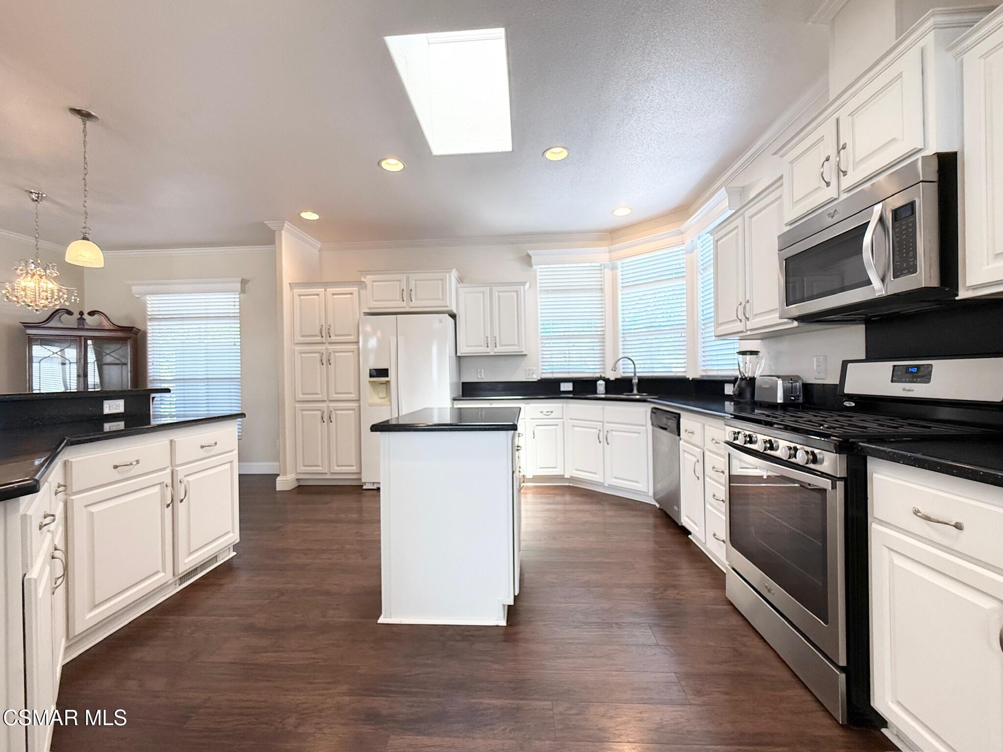 114 Stevens Circle Ventura, CA 93003 - Photo 2 of 29 a large kitchen with stainless steel appliances and white cabinets