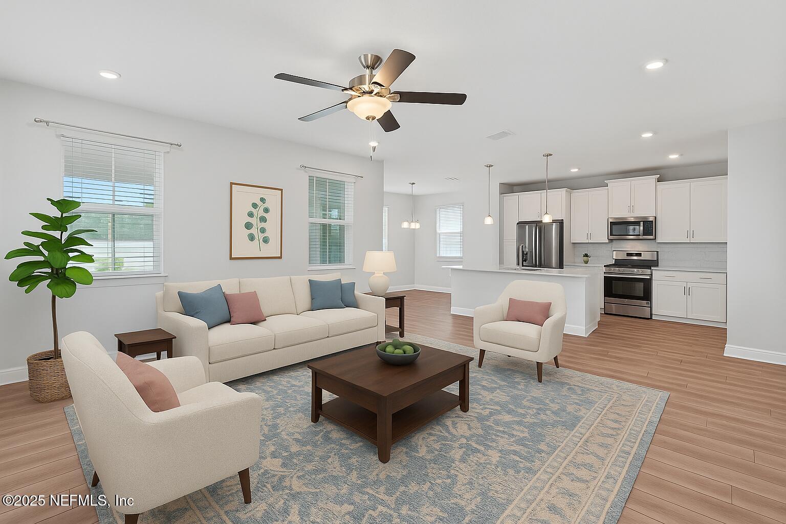 a living room with furniture kitchen view and a potted plant