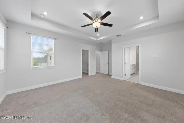 a view of an empty room with a ceiling fan