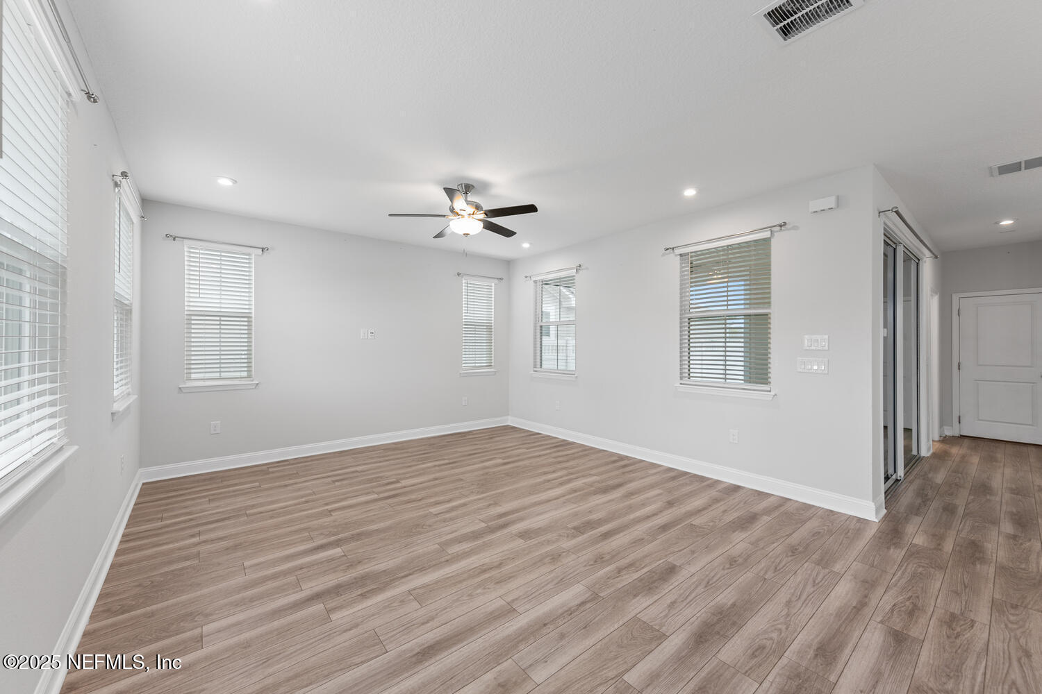 117 Redbud Lane Yulee, FL 32097 - Photo 4 of 20 a view of empty room with wooden floor and fan