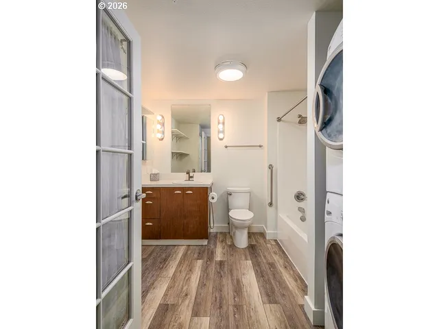 a bathroom with a sink a toilet and a shower