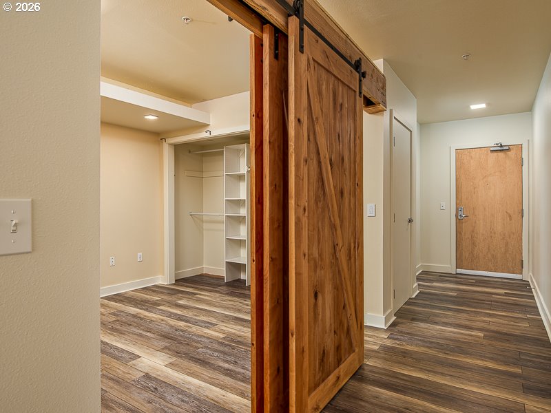 3970 North Interstate Avenue, Unit 208 Portland, OR 97227 - Photo 3 of 20 a view of a hallway with wooden floor and staircase