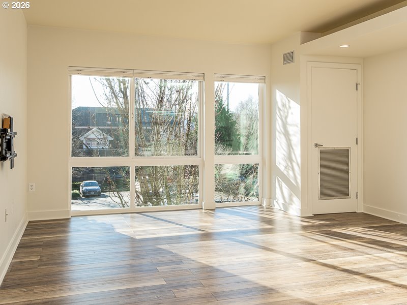 3970 North Interstate Avenue, Unit 208 Portland, OR 97227 - Photo 4 of 20 a view of a room with wooden floor and windows