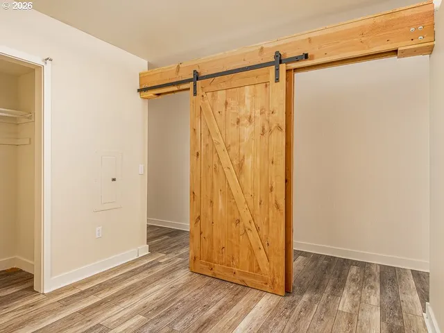 a view of walk in closet with wooden floor